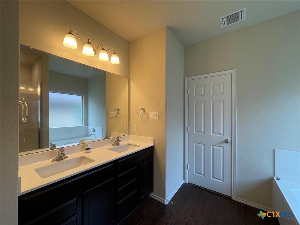 6416 Treiber Drive Temple, TX 76502 - Photo 9 of 19 a bathroom with a double vanity sink and a mirror
