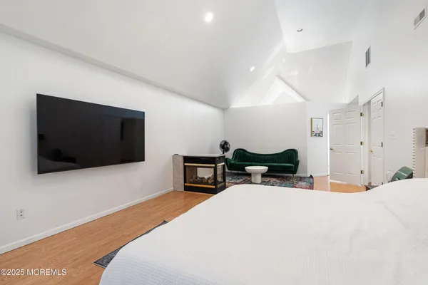 a bedroom with a bed and a television