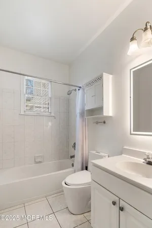 a large white kitchen with granite countertop a large window