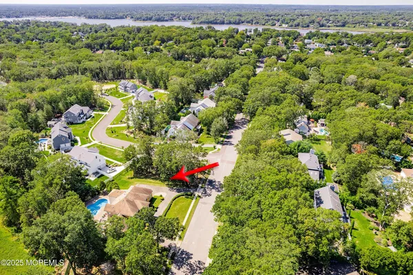 an aerial view of a houses with a yard