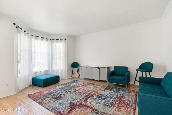 a living room with furniture rug and wooden floor