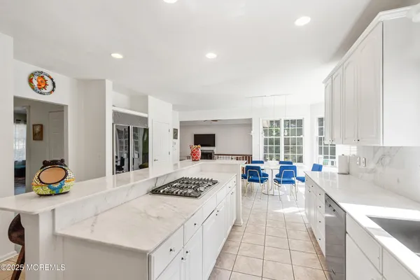 a large kitchen with a table and chairs
