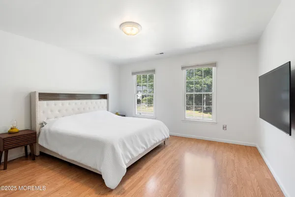 a large bed sitting in a bedroom next to a window