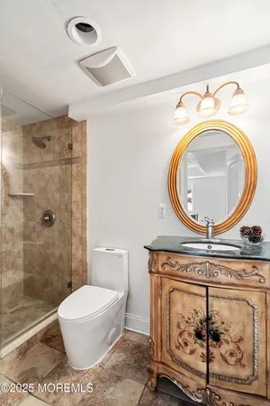 a bathroom with a toilet a sink and a mirror