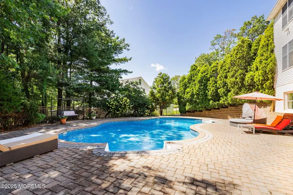 a view of a swimming pool with an outdoor space and seating area