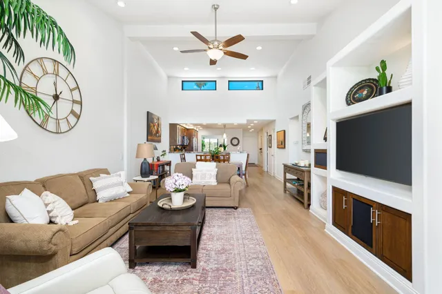 a living room with furniture fireplace and flat screen tv