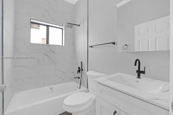 a bathroom with a sink toilet and bathtub