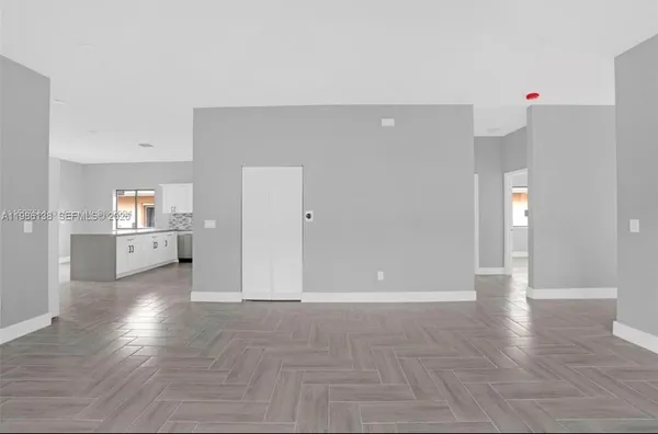 a view of a kitchen with wooden floor and a sink