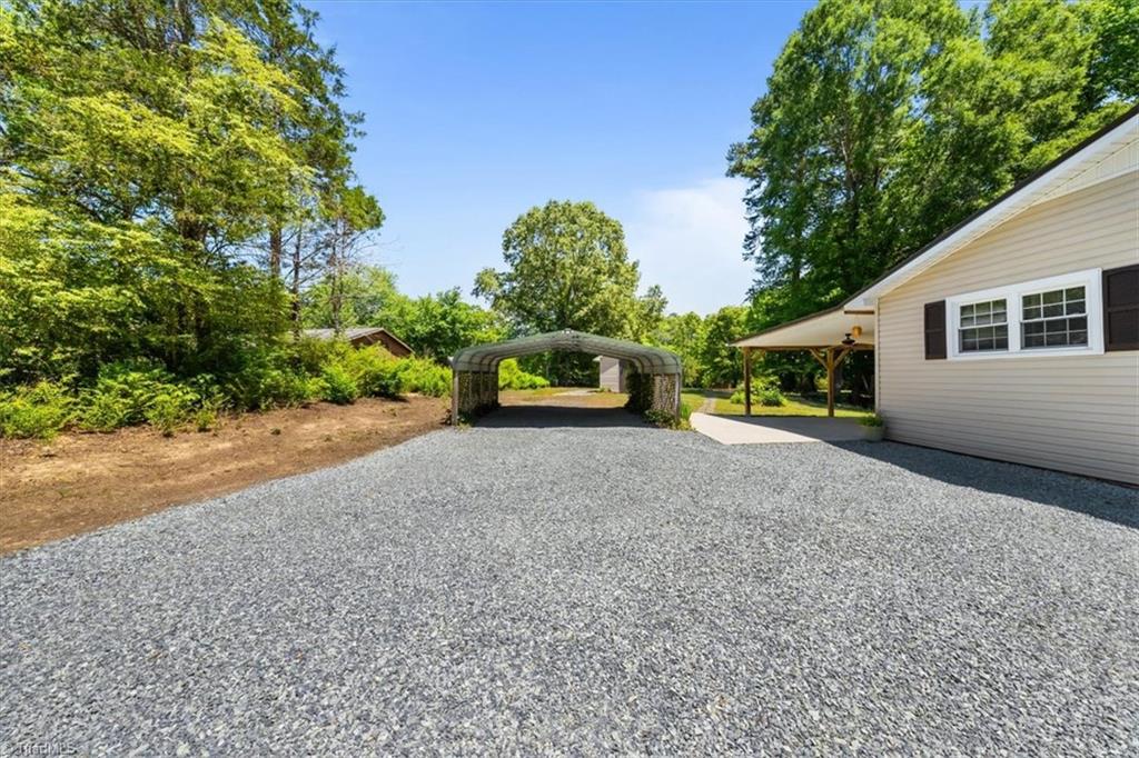 4603 Moffitt Mill Road Ramseur, NC 27316 - Photo 25 of 39 Fresh gravel and landscaping around the 2 car carport