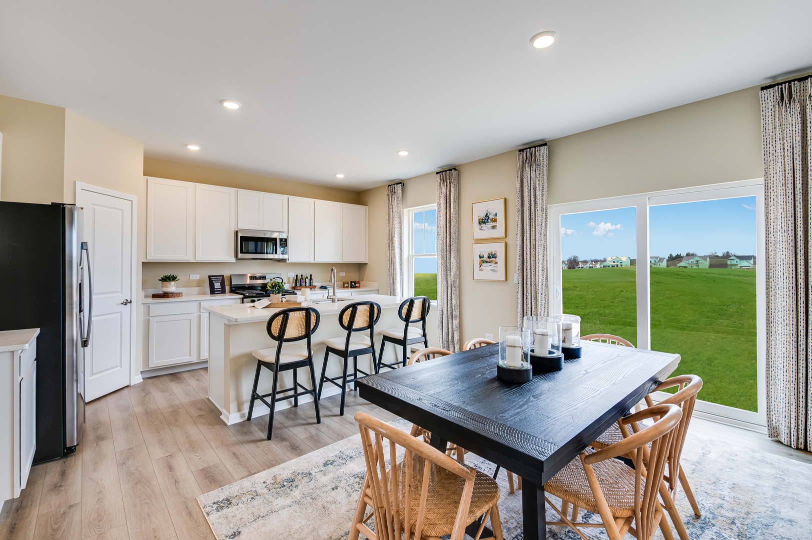1680 Rolling Pass Beecher, IL 60401 - Photo 6 of 26 a kitchen with stainless steel appliances granite countertop a stove a refrigerator a kitchen island a table and chairs