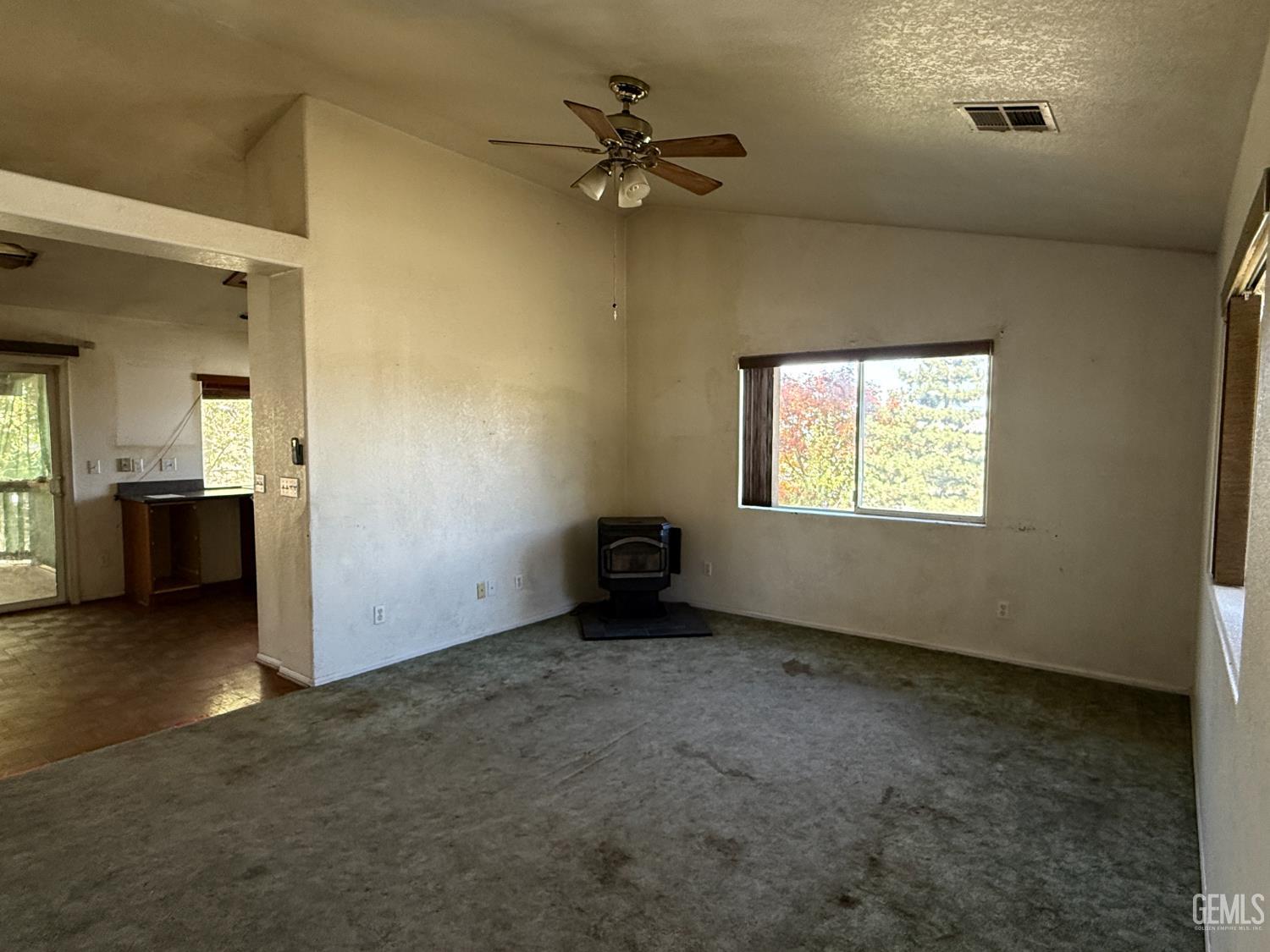 Undisclosed Address Tehachapi, CA 93561 - Photo 3 of 17 an empty room with a window and a ceiling fan