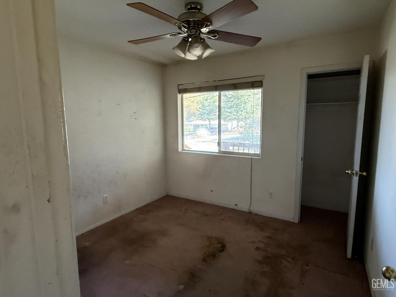 Undisclosed Address Tehachapi, CA 93561 - Photo 7 of 17 an empty room with windows and fan