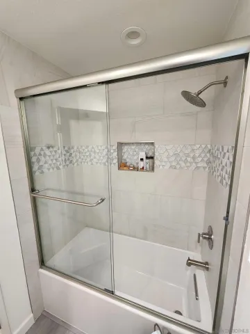 a bathroom with a bathtub and a shower