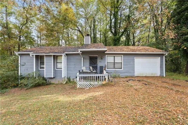 a front view of a house with a garden