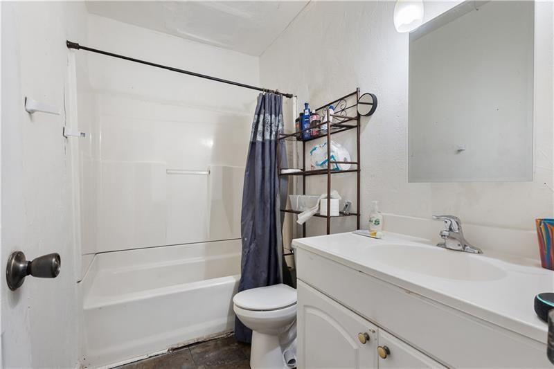 1496 Meadowlark Drive Decatur, GA 30032 - Photo 12 of 27 a bathroom with a sink toilet and shower