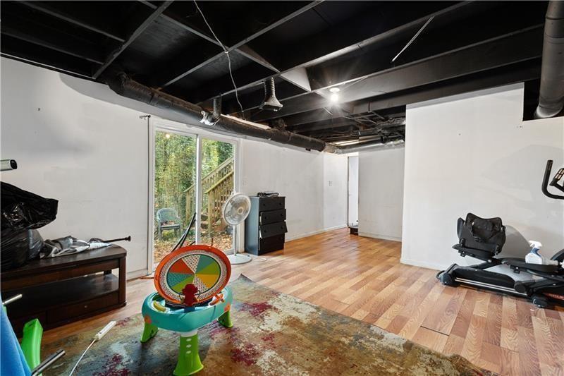 1496 Meadowlark Drive Decatur, GA 30032 - Photo 18 of 27 a room with gym equipment and a mirror