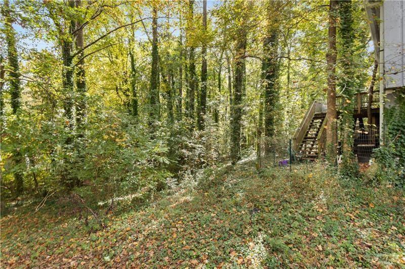 1496 Meadowlark Drive Decatur, GA 30032 - Photo 25 of 27 a view of a yard with plants and large trees