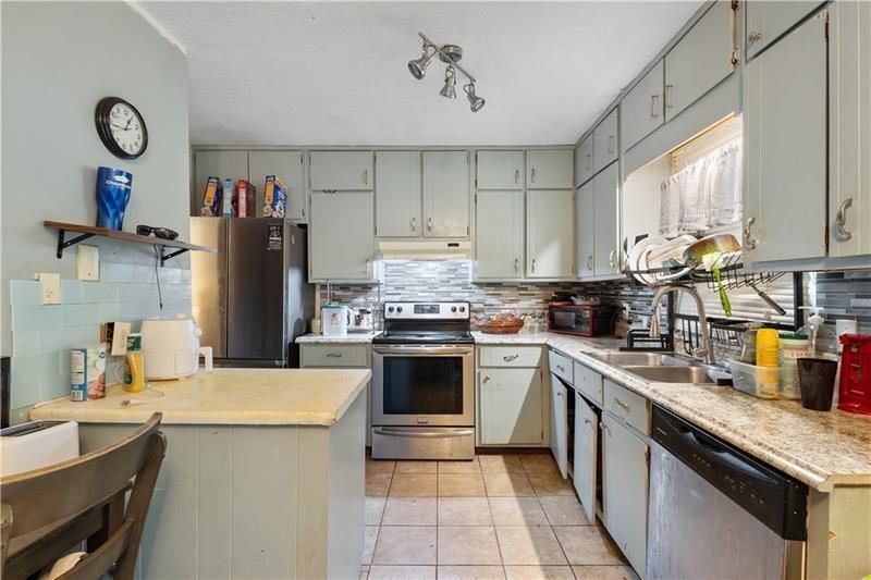1496 Meadowlark Drive Decatur, GA 30032 - Photo 7 of 27 a kitchen with refrigerator and cabinets