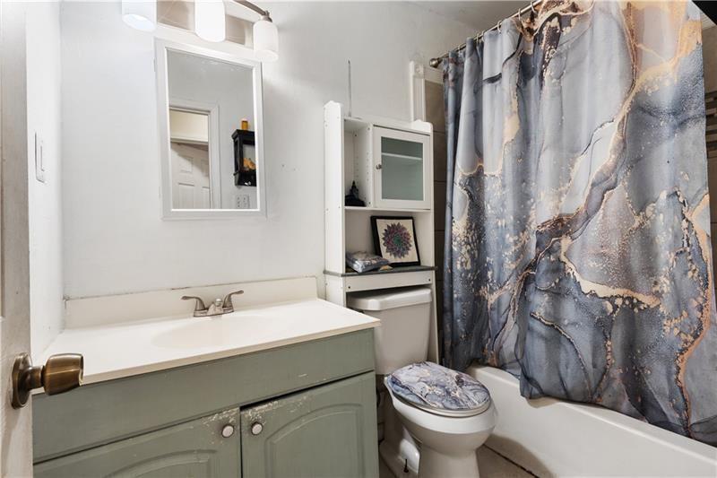 1496 Meadowlark Drive Decatur, GA 30032 - Photo 9 of 27 a bathroom with a sink toilet and shower