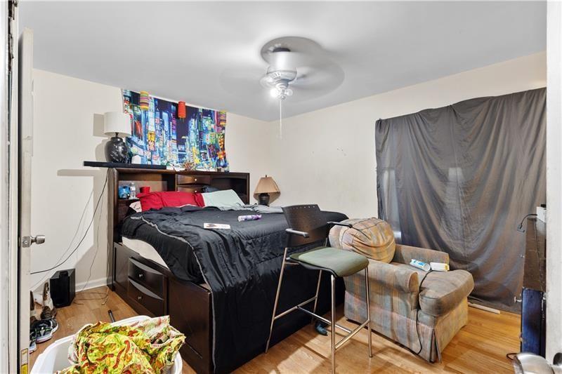 1496 Meadowlark Drive Decatur, GA 30032 - Photo 10 of 27 a bedroom with a bed and a chandelier