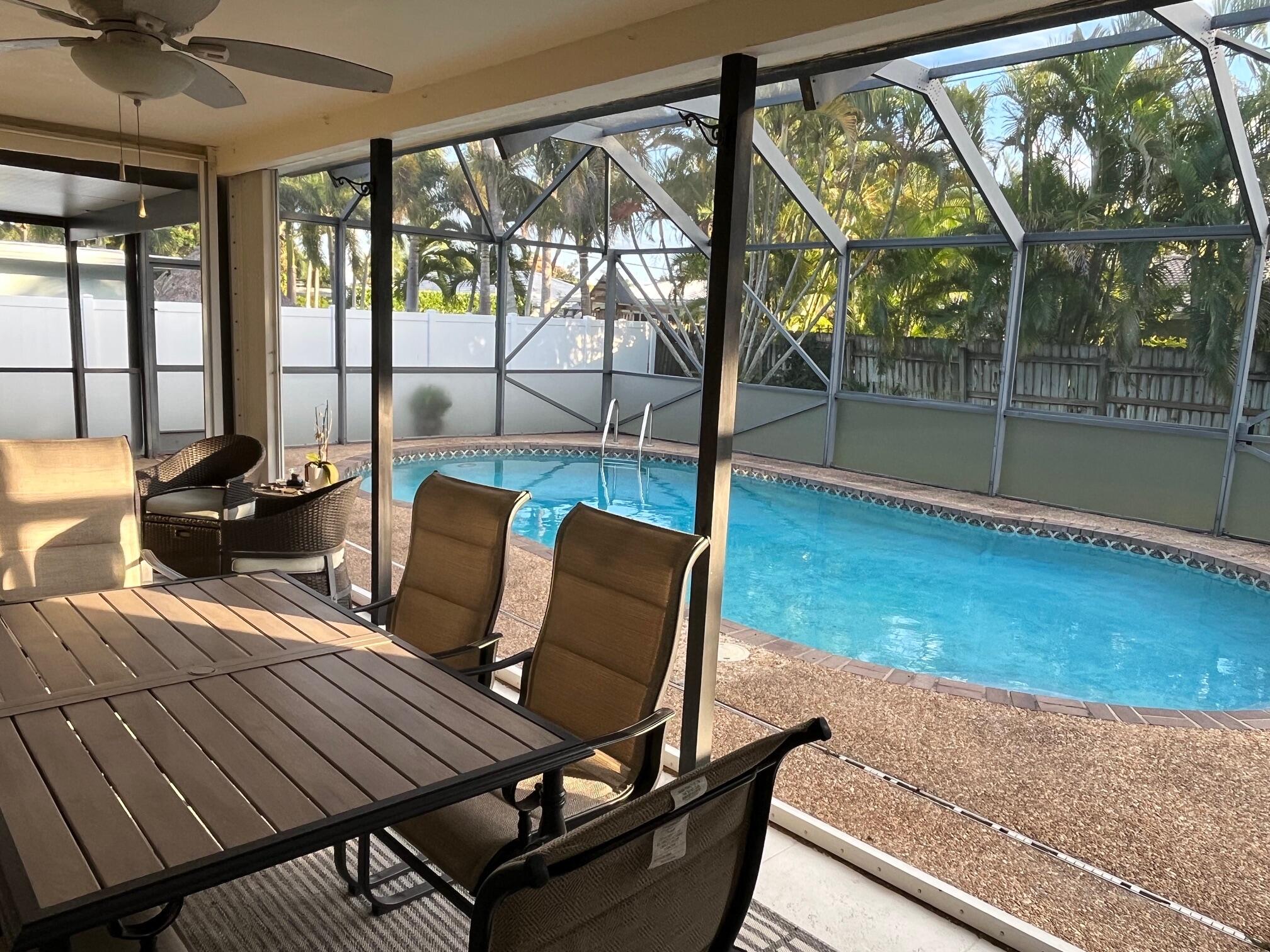 1260 Southwest 8th Street Boca Raton, FL 33486 - Photo 2 of 12 a bedroom with a bed and wooden floor