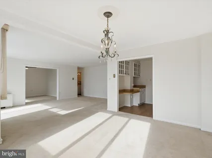 an empty room with a ceiling fan and a window
