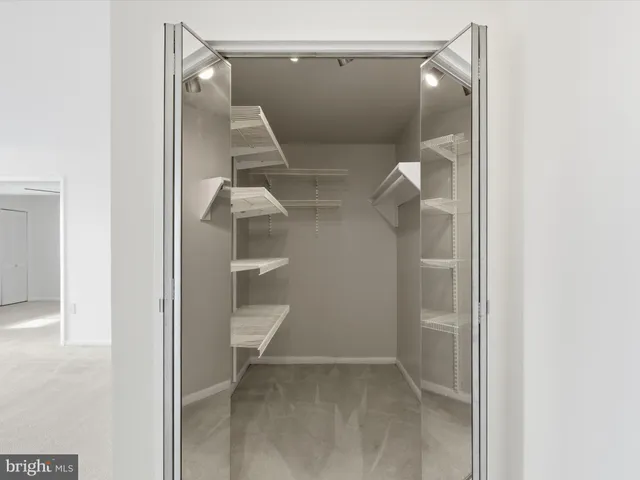 a view of a room with a chandelier and kitchen