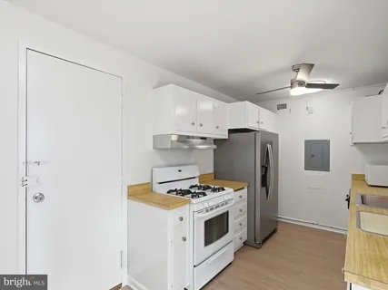 a kitchen with stainless steel appliances a refrigerator and a stove