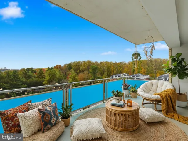 a balcony with furniture and a potted plant