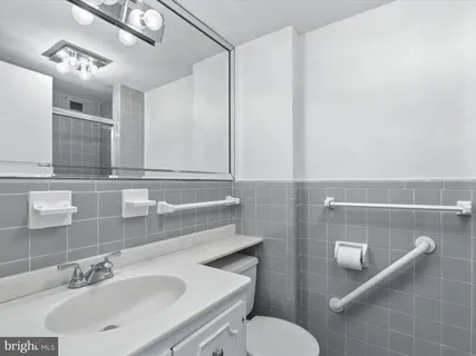 a bathroom with a glass shower door