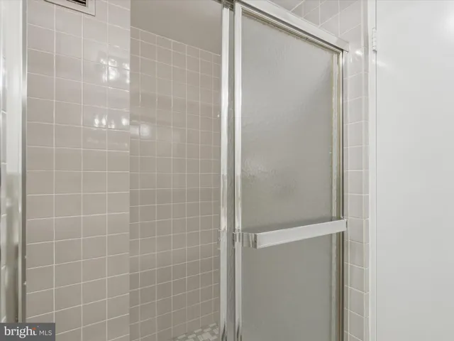 a bedroom with a bed and potted plant