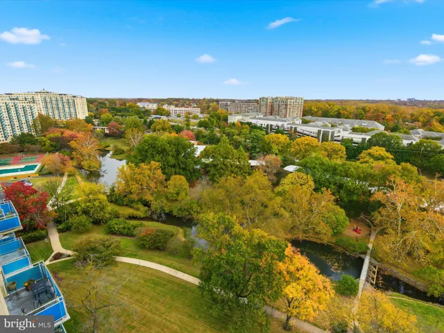 a dining room with furniture and a large window