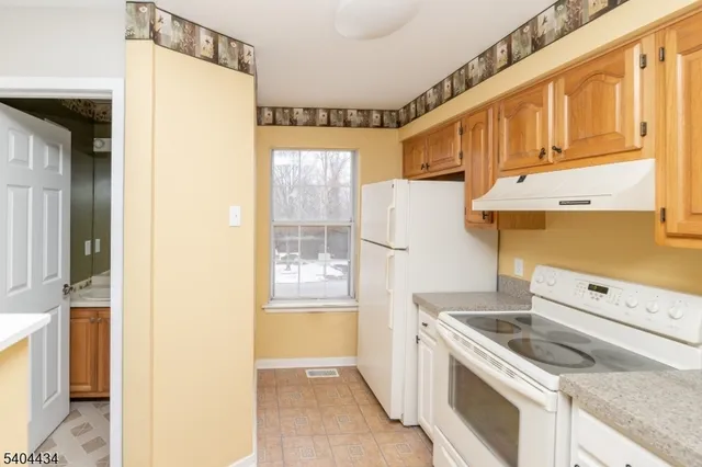 a kitchen with a stove a refrigerator and a sink