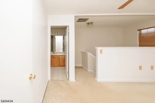 a spacious bathroom with a granite countertop sink toilet and shower