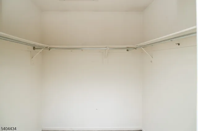 a view of staircase with white walls and a window