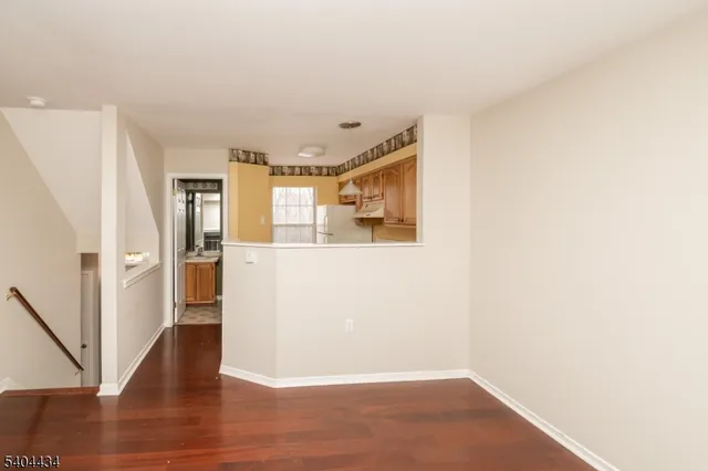 a view of a kitchen with wooden floor and a large window