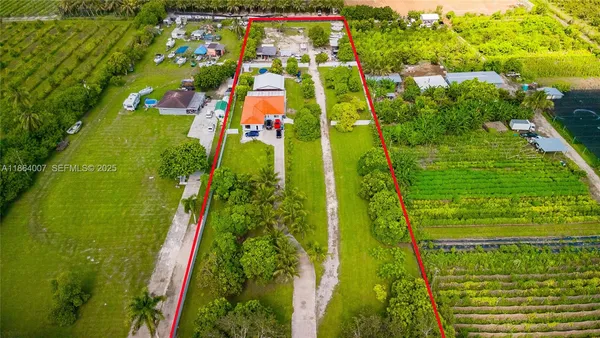 an aerial view of residential houses with outdoor space and swimming pool