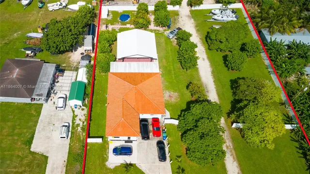 a view of a swimming pool with a patio and a yard