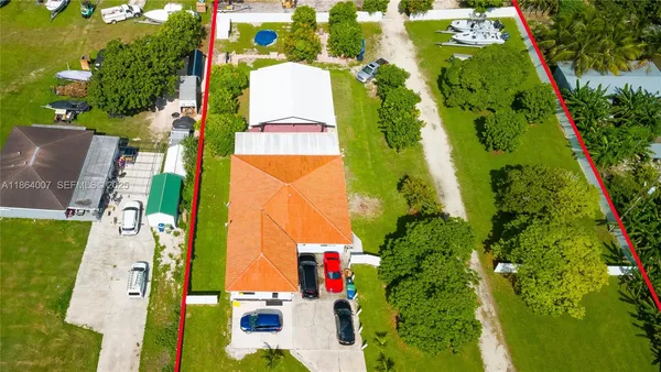 a view of a swimming pool with a patio and a yard