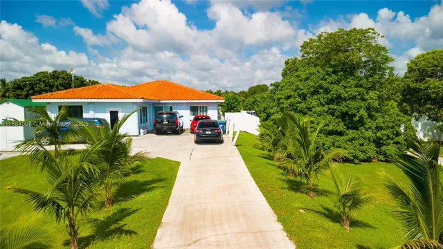 a living room with furniture and a dining table with wooden floor