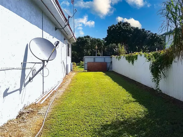 a kitchen with stainless steel appliances kitchen island granite countertop a refrigerator and a stove top oven