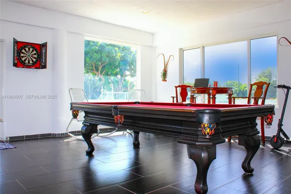 a living room with furniture a kitchen view and a kitchen counter space