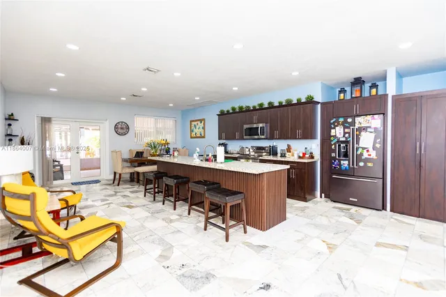 a view of a kitchen with a sink and a large window