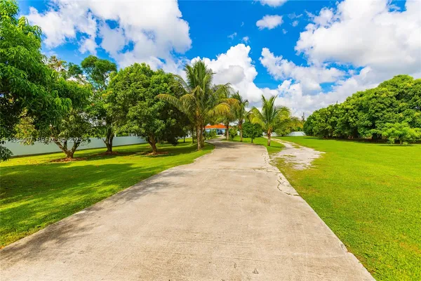a kitchen with stainless steel appliances granite countertop sink stove and refrigerator