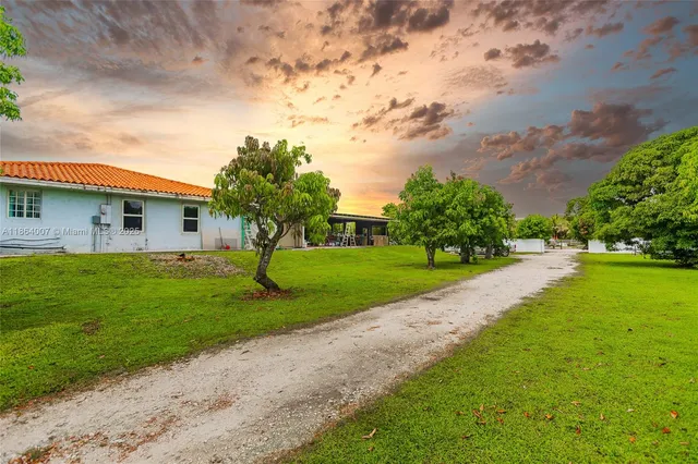 a kitchen with refrigerator and chairs