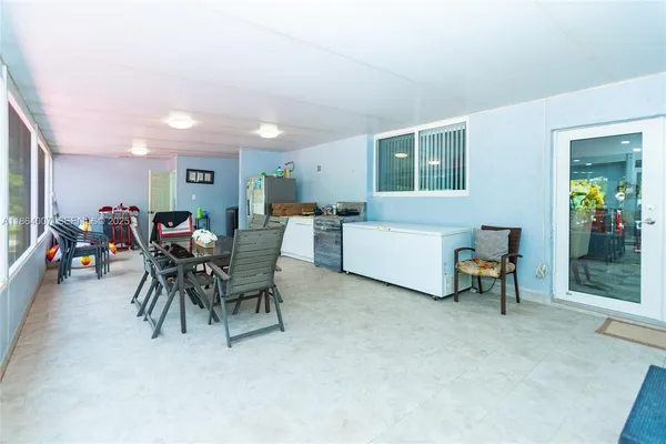 a view of patio with a table and chairs under an umbrella