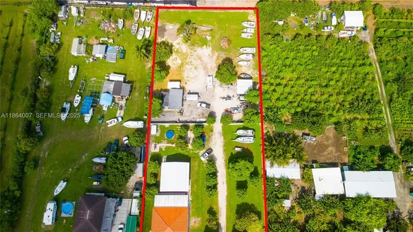 a view of a yard with large trees