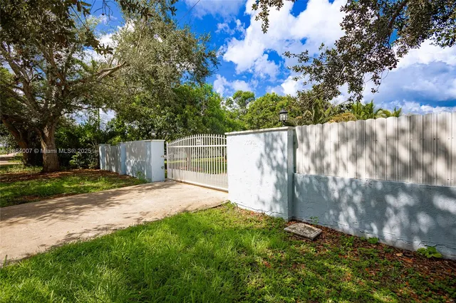 a view of swimming pool with a table and chairs under an umbrella