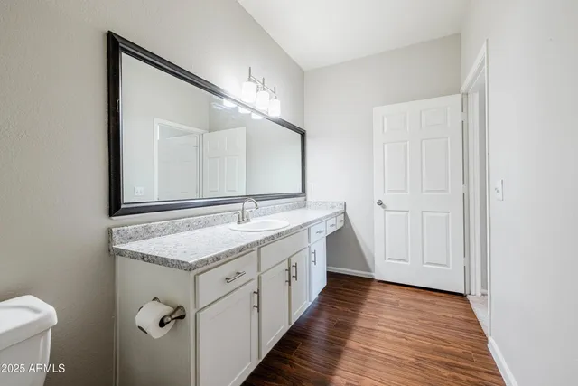 a bathroom with 2 sink and a mirror