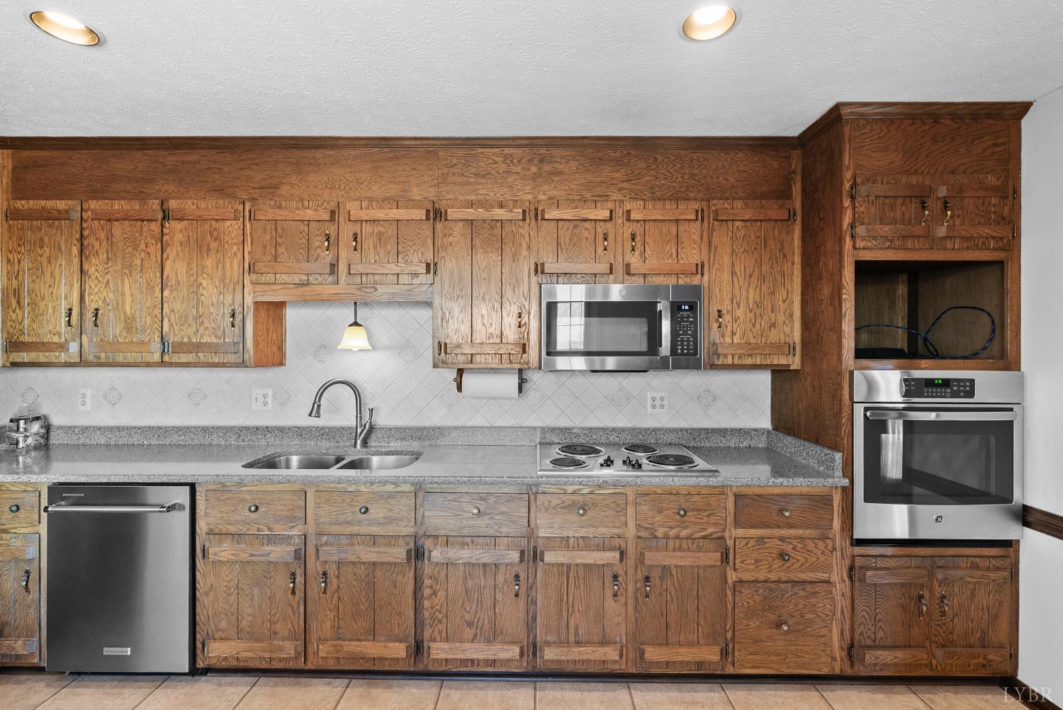 1159 Cifax Road Forest, VA 24551 - Photo 12 of 60 a kitchen with stainless steel appliances granite countertop a stove a sink and a microwave